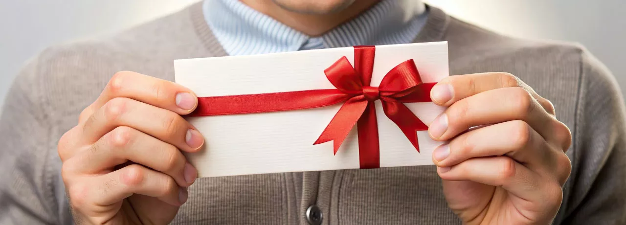 Employee holding their gift from work