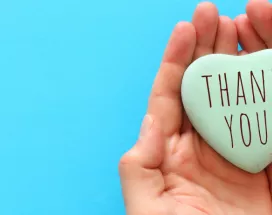 Image shows two hands cupped together with a heart in the middle that says "Thank You"