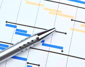 Image shows a pen resting over a printed gantt chart