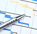 Image shows a pen resting over a printed gantt chart