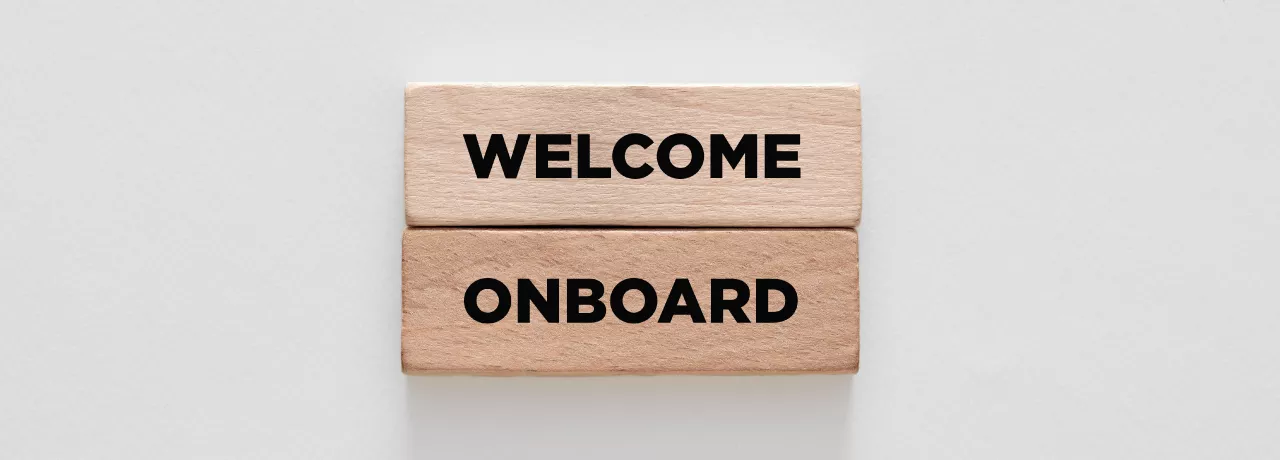 Image shows two wooden blocks stacked on top of each other that say "Welcome Onboard" 
