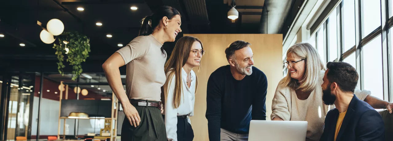 Engaged team working together over a laptop 