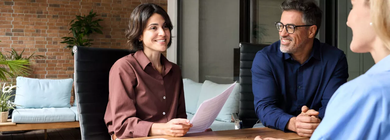 A new employee getting set up with paperwork during onboarding 