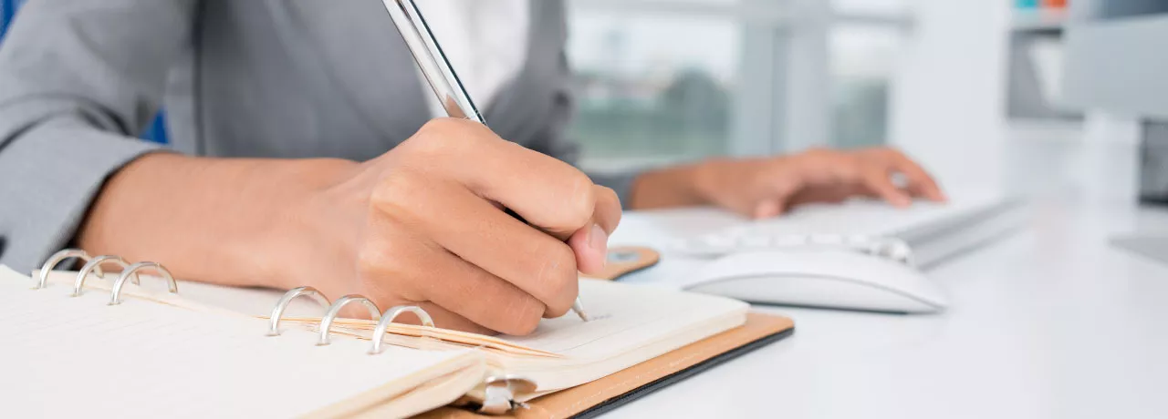 An administrator writing down a task 