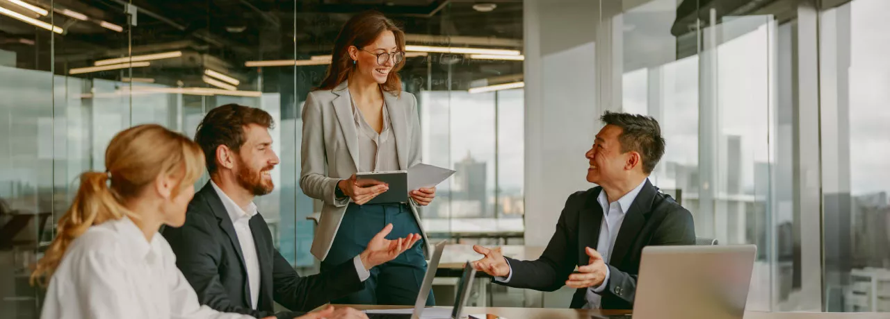 A high performing team at work collaborating and brainstorming around a table. 