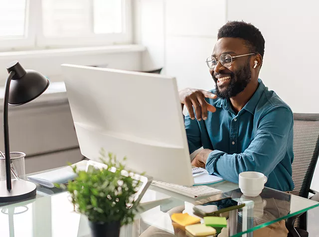 man smiling at computer