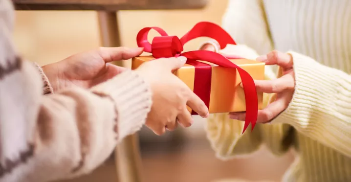People giving each other a holiday gift