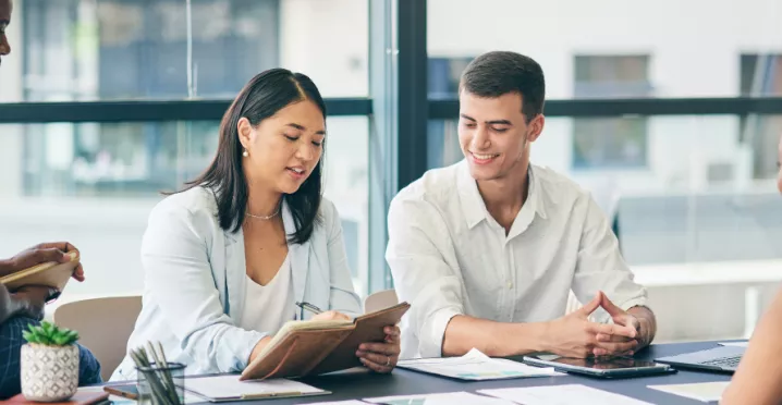 Coworkers gathered around a table working on a project