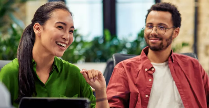 Four coworkers talking in an company lounge