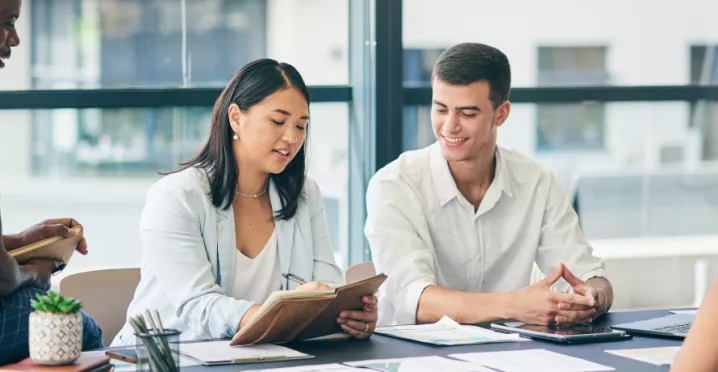 Four employee sitting around a table discussing a project