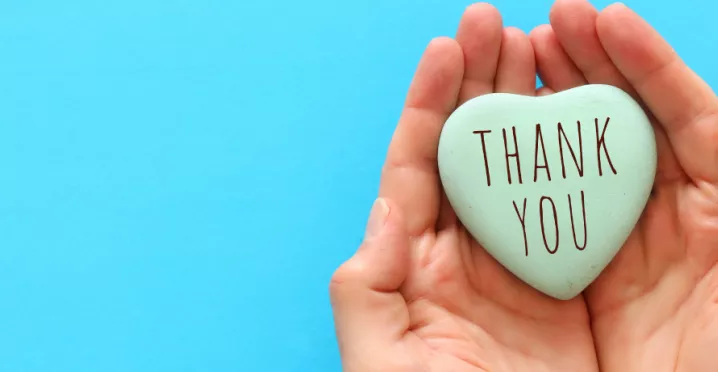 Image shows two hands cupped together with a heart in the middle that says "Thank You"