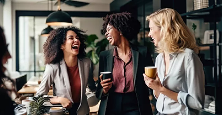 women laughing in office
