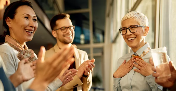 A team clapping for their colleague
