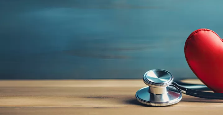 Image shows a toy heart and stethoscope sitting on a table 
