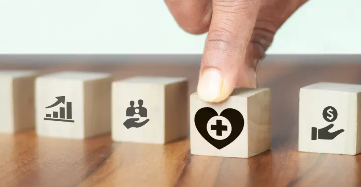 Image shows a hand grabbing a block with a heart on it.