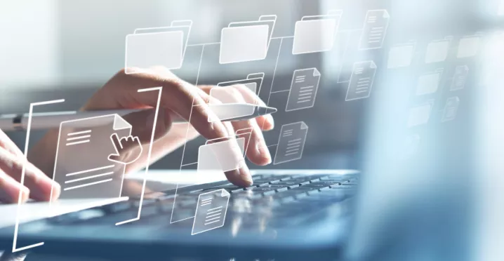 Hands typing on a computer with transparent icons hovering in front