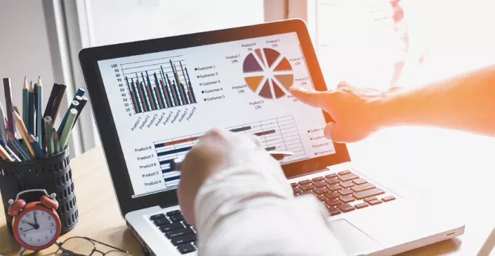 Two people looking at data on a computer