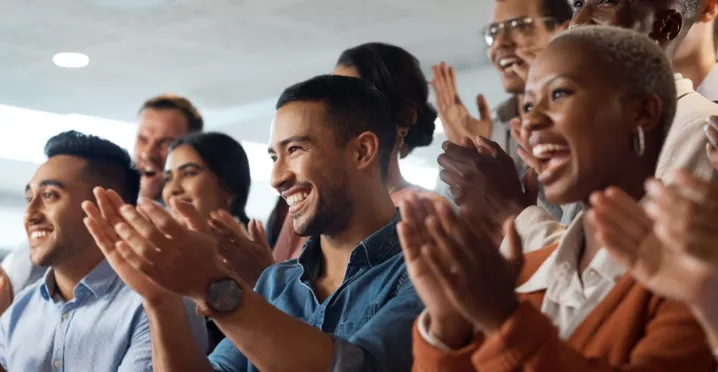 Shows several people clapping the same direction