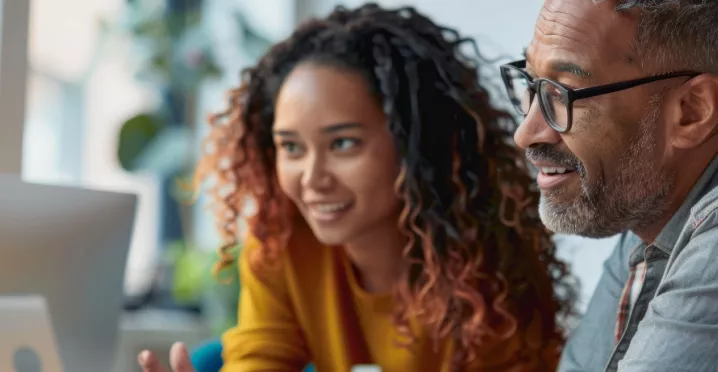Two employees looking at a computer