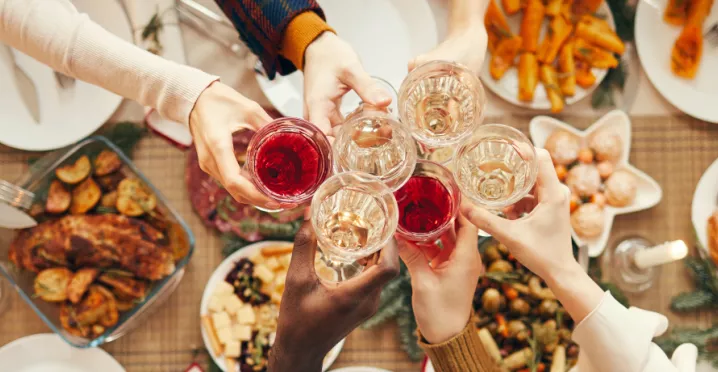 Employees celebrating at their office holiday party with drinks and food