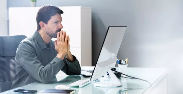 An upset employee sitting at their desk