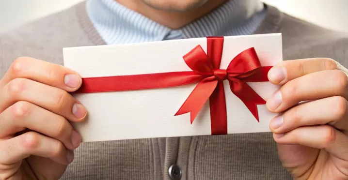 Employee holding their gift from work