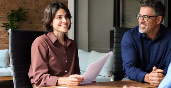 A new employee getting set up with paperwork during onboarding