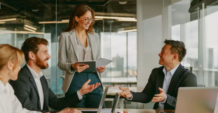 A high performing team at work collaborating and brainstorming around a table.