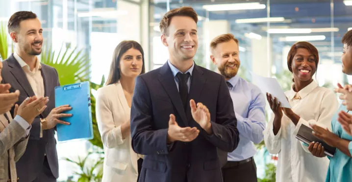 A group of employees celebrating with one another in the office