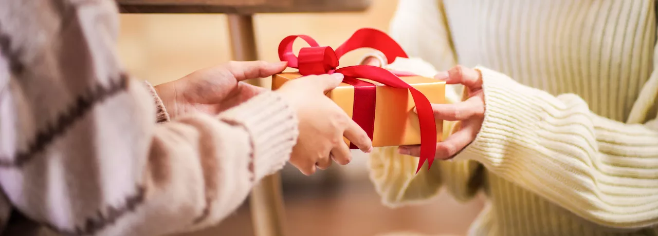 People giving each other a holiday gift