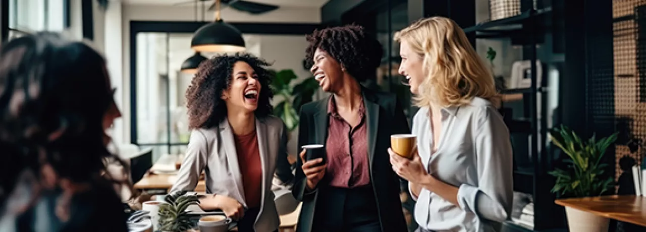 women laughing in office