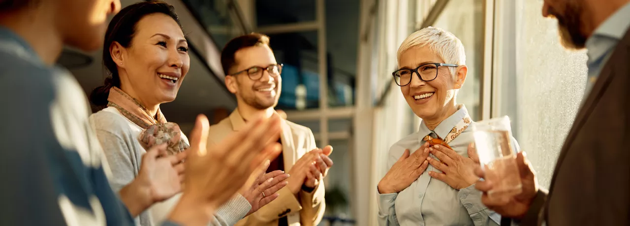 A team clapping for their colleague