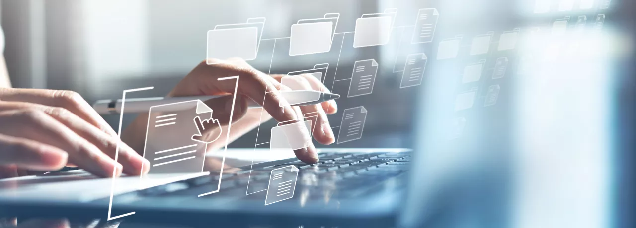 Hands typing on a computer with transparent icons hovering in front