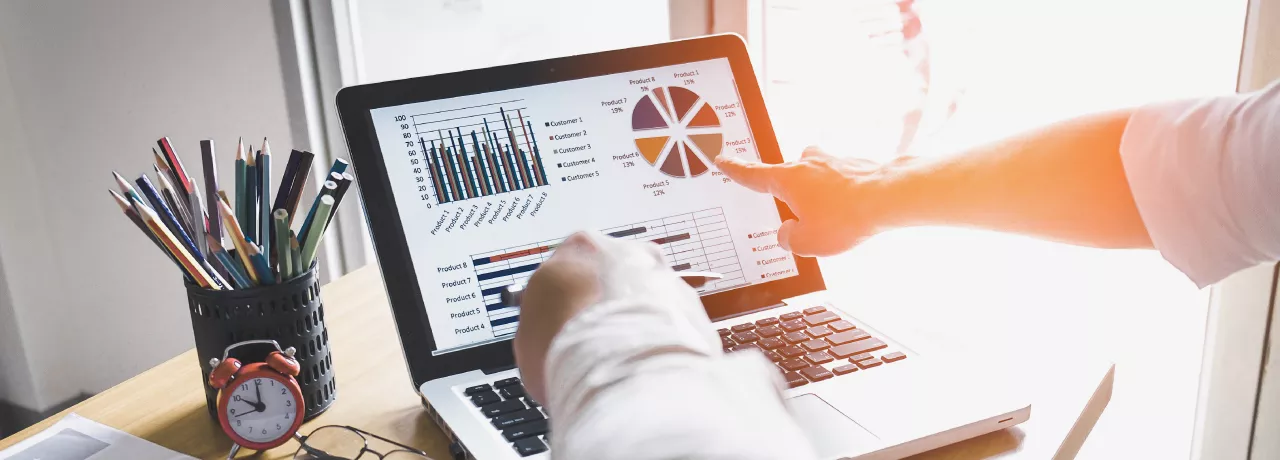 Two people looking at data on a computer