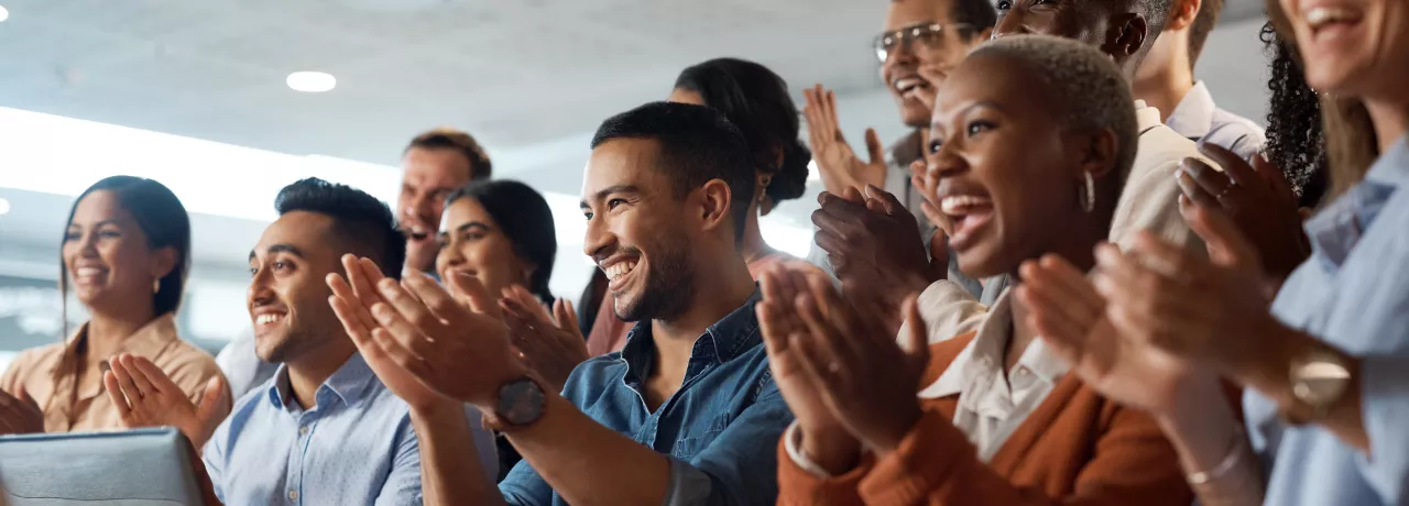 Shows several people clapping the same direction
