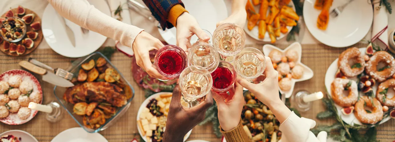 Employees celebrating at their office holiday party with drinks and food