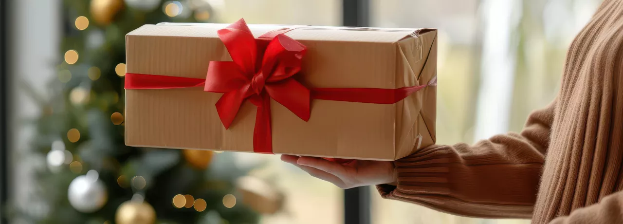 An employer gifting their employee a holiday gift