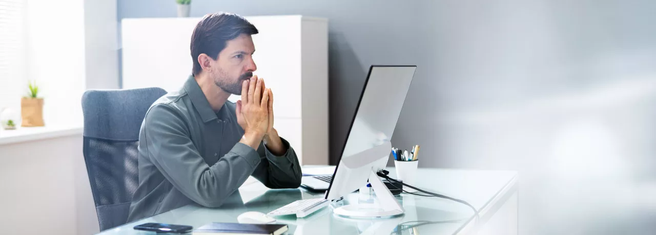 An upset employee sitting at their desk