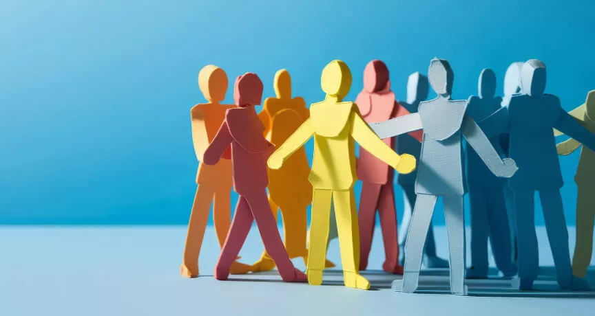 Paper stick figures huddled in a group