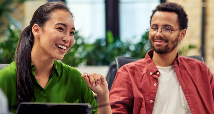 Four coworkers talking in an company lounge