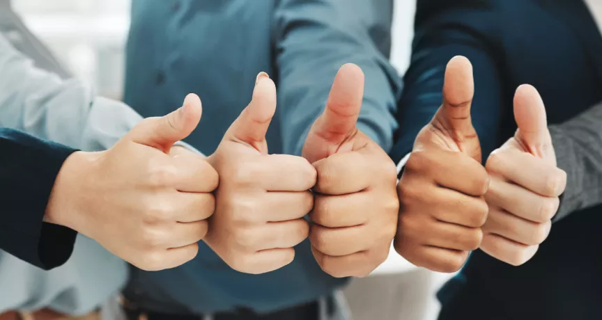 Five people giving a thumbs up