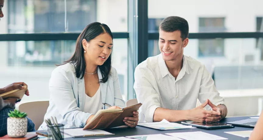 Four employee sitting around a table discussing a project