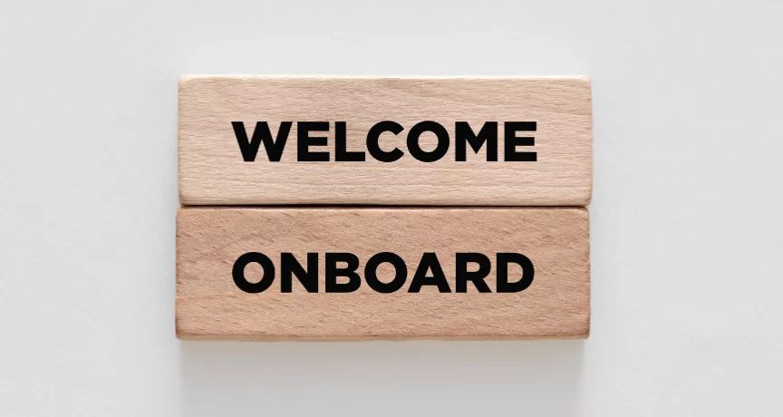 Image shows two wooden blocks stacked on top of each other that say "Welcome Onboard"
