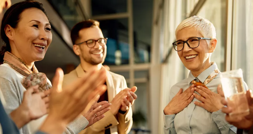 A team clapping for their colleague
