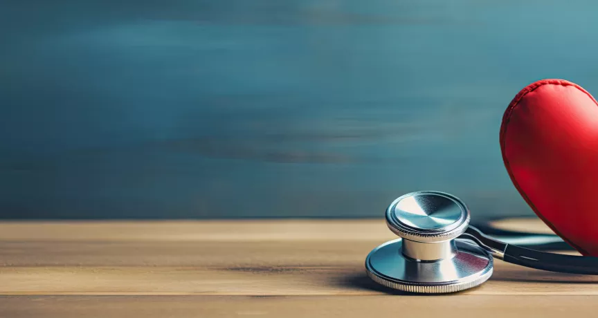 Image shows a toy heart and stethoscope sitting on a table 
