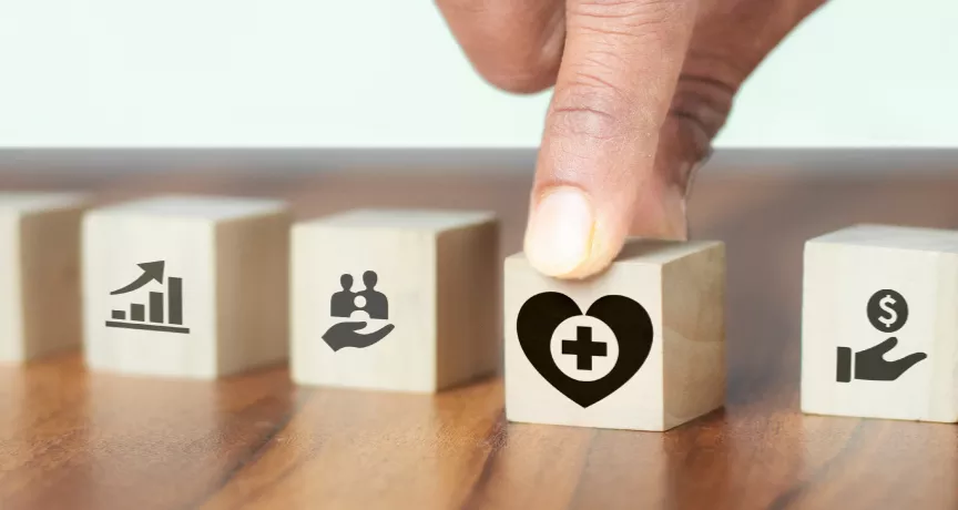 Image shows a hand grabbing a block with a heart on it.