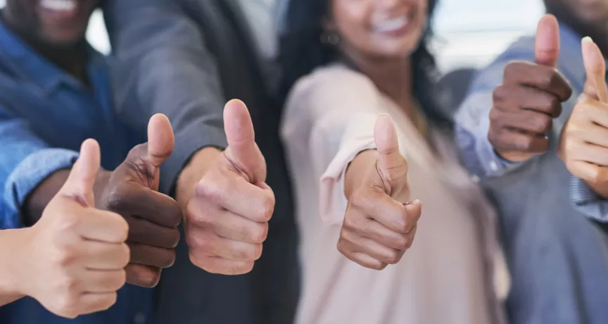 Shows six people giving a thumbs up