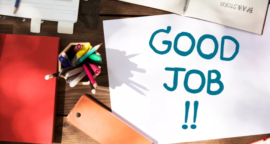 Shows a note that says "Good Job!" on a desk