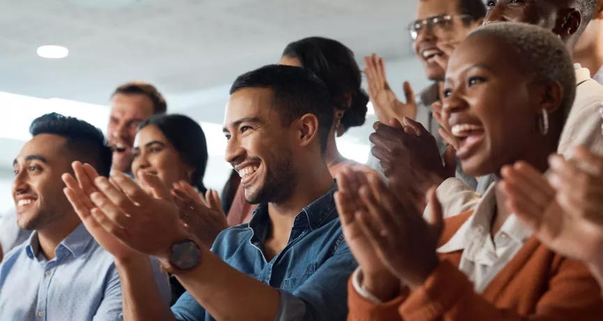Shows several people clapping the same direction