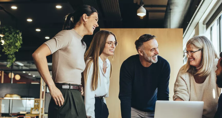 Engaged team working together over a laptop